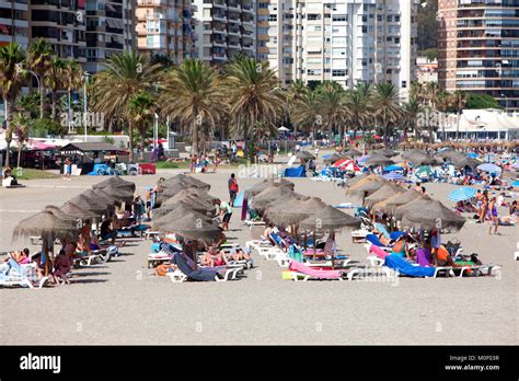 Sunbathers Tourists And Locals Enjoying The Sun Sea And Sand At Playa