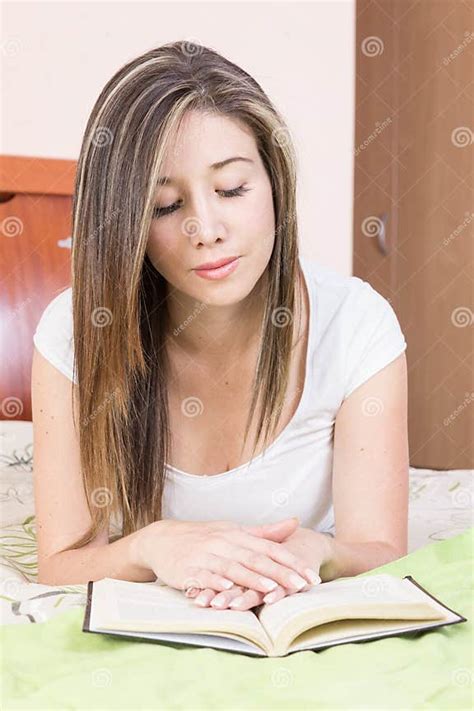 Pretty Young Girl Lying On Her Stomach Reading A Stock Image Image Of