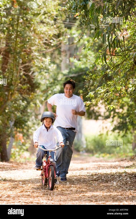 Father And Son Riding Bike Stock Photo Alamy