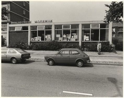 Two Cars Parked In Front Of A Building