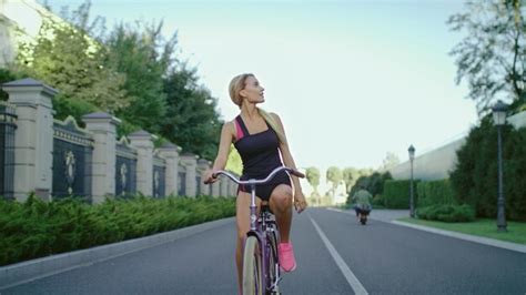 Premium Photo Slim Woman In Sportswear Riding On Bicycle While Training In Summer Park