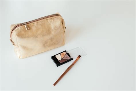 Premium Photo Golden Cosmetic Bag With Cosmetic Beauty Products