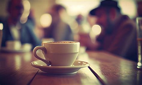 Premium AI Image A Cup Of Hot Coffee On The Table In A Cafe With People Small Depth Of Field