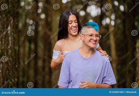 Happy Hispanic Lesbian Couple Hugging In A Forest Stock Photo Image