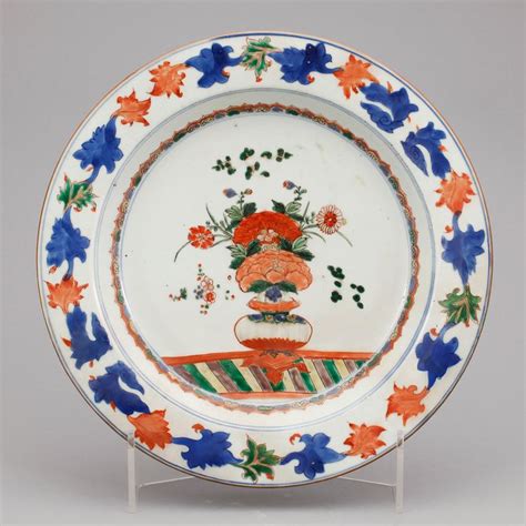 An Ornately Decorated Plate With Flowers On It