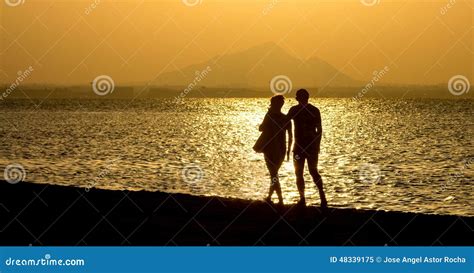 Romantic Stroll Along The Beach At Sunset Couple Stock Image Image Of