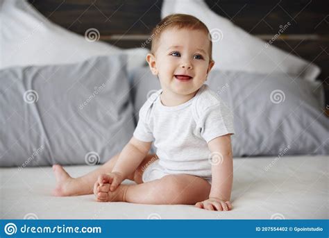 Smiling Baby Sitting On Bed Stock Photo Image Of Curiosity Clothing