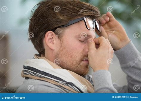 Man With Tired Eyes After Long Work Holding Eyeglasses Stock Image