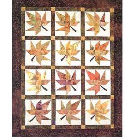 A Quilted Wall Hanging With Leaves On It