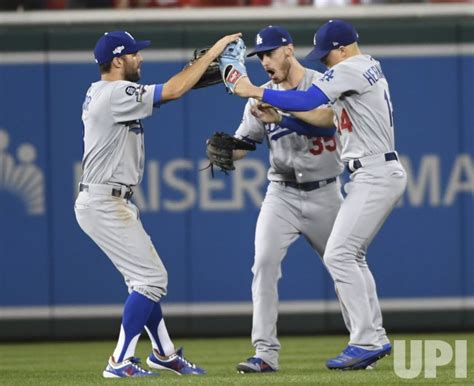 Photo: Dodgers outfielders celebrate win during National League Division Game Three Dodgers at ...