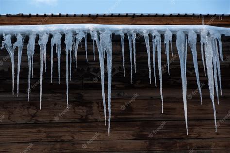 Premium Photo Beautiful Huge Icicles Hang From The Roof Of The