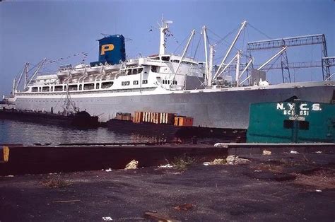 The Large Boat Is Docked At The Dock