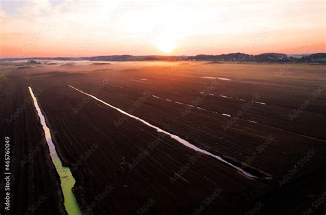 Peat Extraction Site In Fog On Sunset Collecting Peat On Peatlands