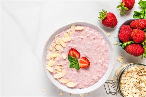 Overnight Oats With Fresh Strawberries Almonds And Mint In A Bowl On