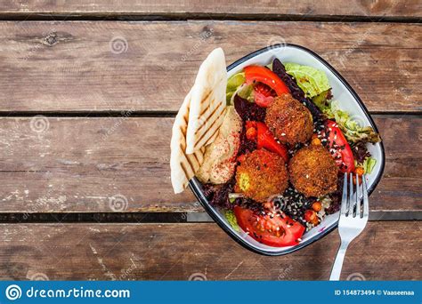 Israeli street food. Falafel salad with hummus, beetroot and vegetables ...