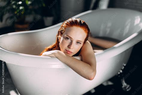 Portrait Of A Beautiful Seductive Young Red Haired Taking Bath In Spa