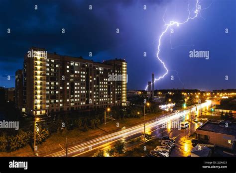 A Lightning Strike During A Thunderstorm Against The Background Of A