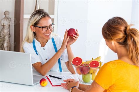 Doctor Nutritionist Dietician And Female Patient On Consultation In