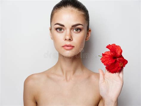 Woman Holding A Red Flower In Her Hand On A Light Background Naked