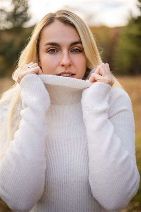 Beautiful Woman With White Dress And Black Boots In A Fall Scene