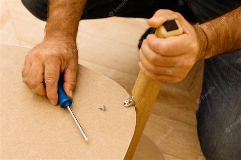 Premium Photo Assembling Wooden Furniture At Home With A Screwdriver