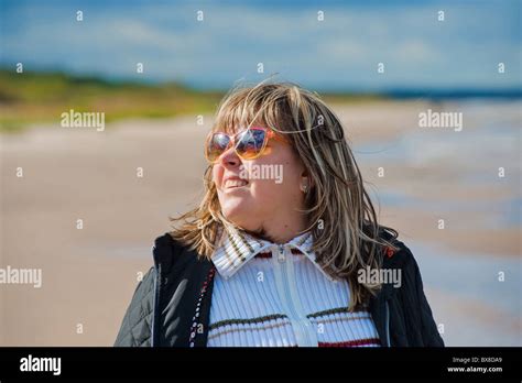 Portrait Of Mature Woman In Sunglasses Relaxing At The Baltic Sea In