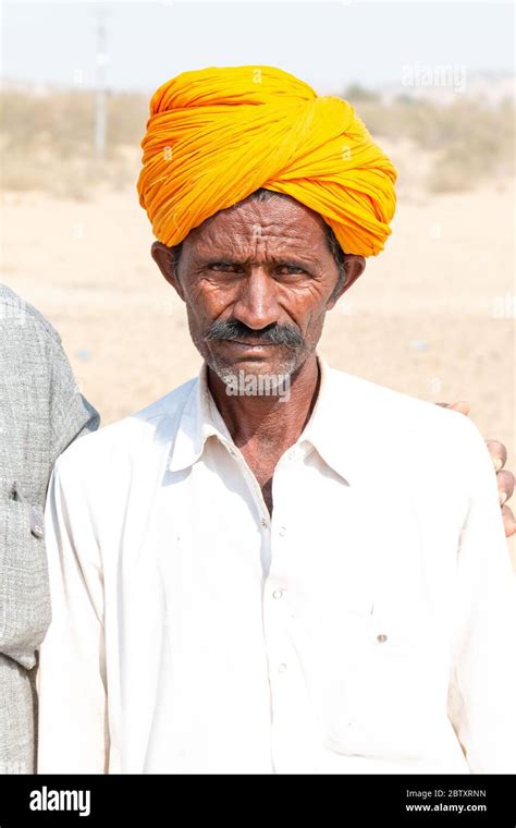 Portrait Of A Man From Jaisalmer Standing In The Thar Desert With