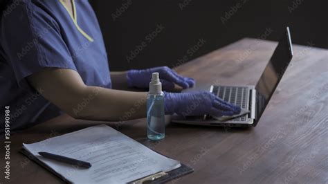 Disinfection Of The Work Surface Nurse Wipes The Keyboard Of Laptop