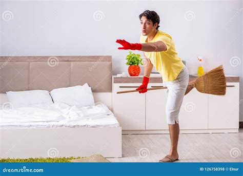 The Young Handsome Man Cleaning In The Bedroom Stock Photo Image Of