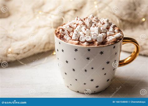 Cup Of Delicious Hot Cocoa With Marshmallows On White Wooden Table