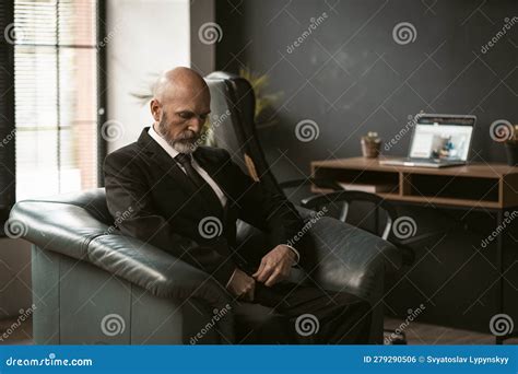 Sad And Contemplative Old Mature Senior Man Sits In Dignified Leather