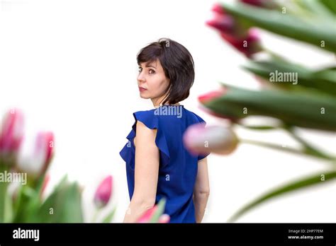 A Brunette Woman 35 40 Years Old Blue Blouse Against The Background Of Spring Tulips Isolated