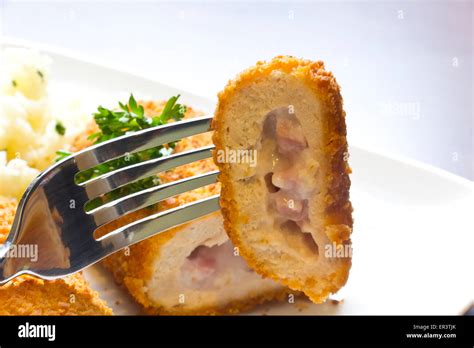 Breaded Stuffed Chicken Cordon Bleu With Green Peas White Rice And