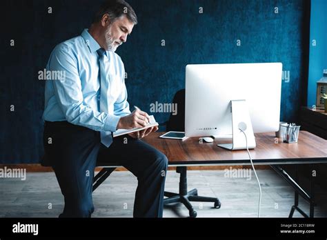 Concentrated At Work Focused Mature Businessman Working And Taking