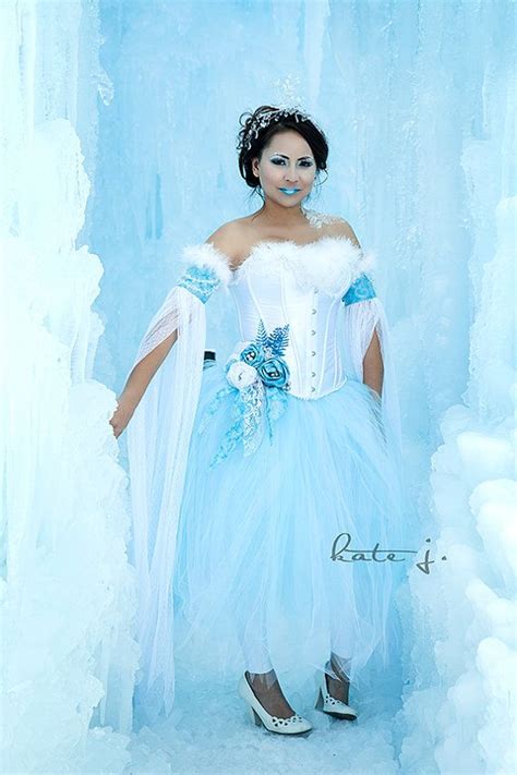 a woman dressed in blue and white posing for a photo with ice ...