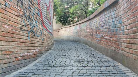 Premium Photo Sidewalk By Wall In City