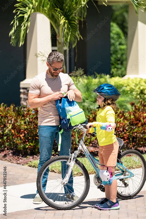 Father Helping Son Get Ready For School Father And Son On The Bicycle