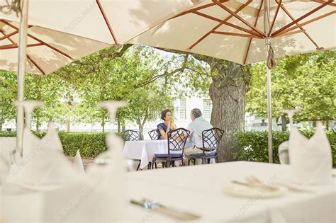 Mature Couple Dining On Resort Patio Stock Image F024 9265