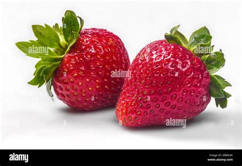 Two strawberries isolated on white Stock Photo - Alamy
