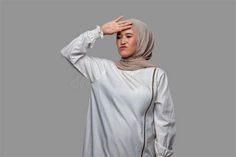 Beautiful Woman Hijab Posing With One Hand On Her Head While Closing