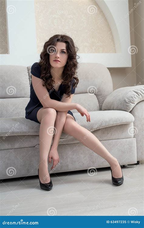 Stylish Brunette Sitting On Couch In Hotel Room Stock Image Image Of