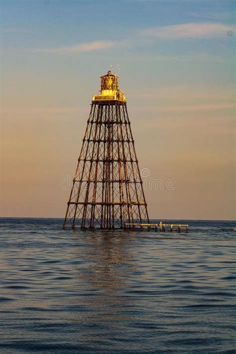 Beautful View Of The Sand Key Lighthouse Surrounded By Water Against