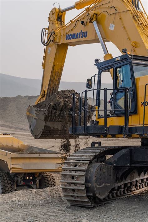 A Komatsu Pc1250 Excavator Loads Ore Into A Komatsu Hm400 Dump Truck