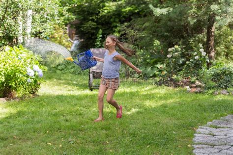 Girl with a Watering Can in the Summer Stock Photo - Image of activity ...