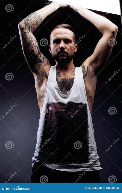 A Man With Tattooes On His Arms Silhouette Of Muscular Body Stock