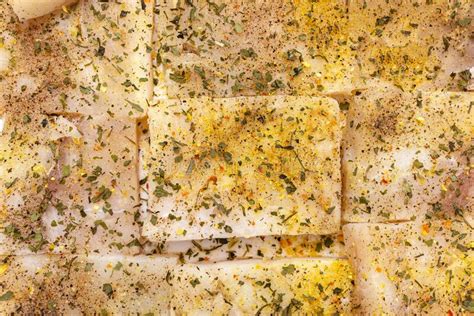 Background Made Of Cod Fish Fillet Cut Into Squares And Sprinkled With