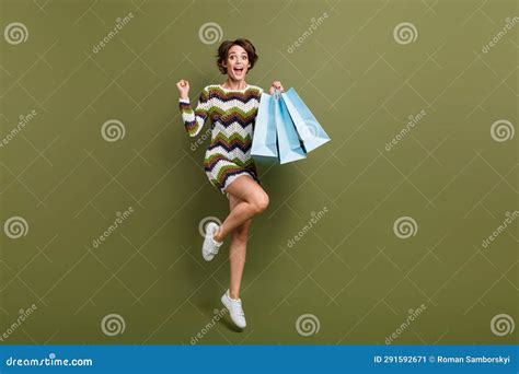 Full Length Photo Of Lucky Excited Lady Wear Striped Outfit Jumping High Rising Fist Bargains