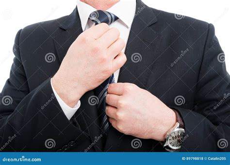 Close Up Of Elegant Man Adjusting His Tie Wearing Suit Stock Photo