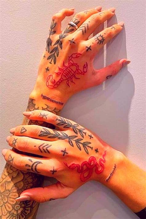 Two Hands With Tattoos On Their Arms