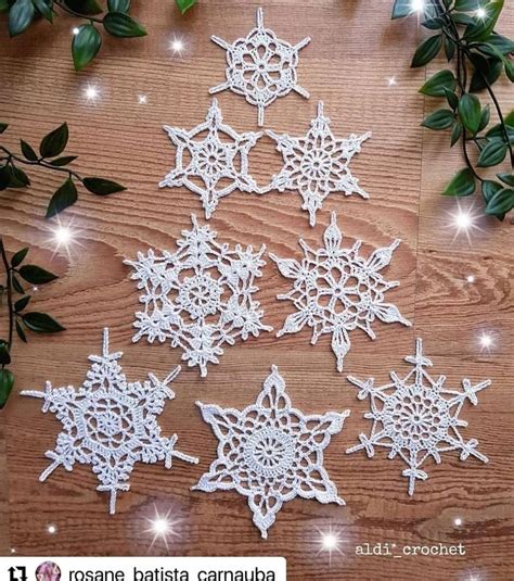 Several Snowflakes Are Shown On A Wooden Table